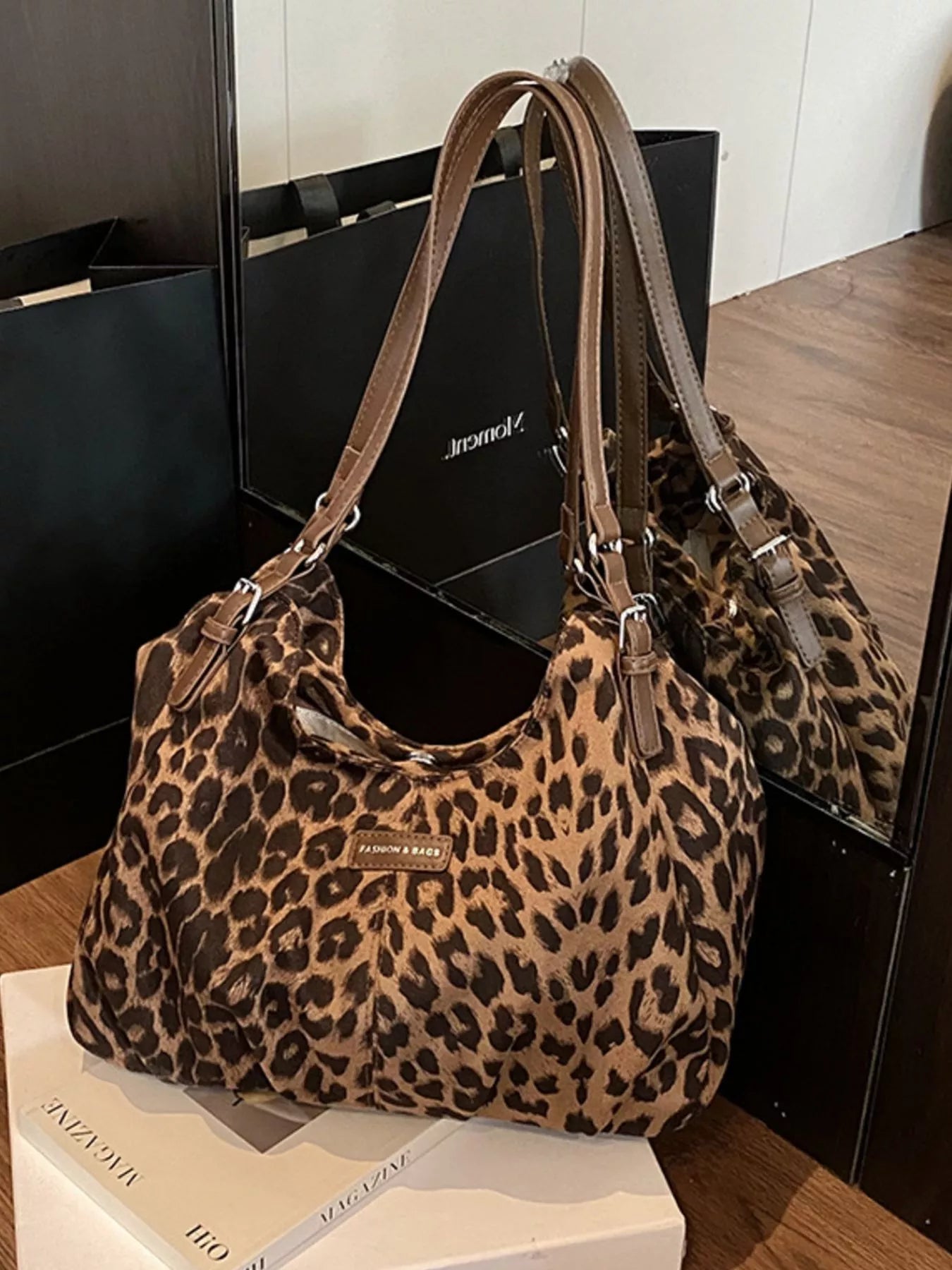 Leopard print handbag on a wooden surface with a blurred background