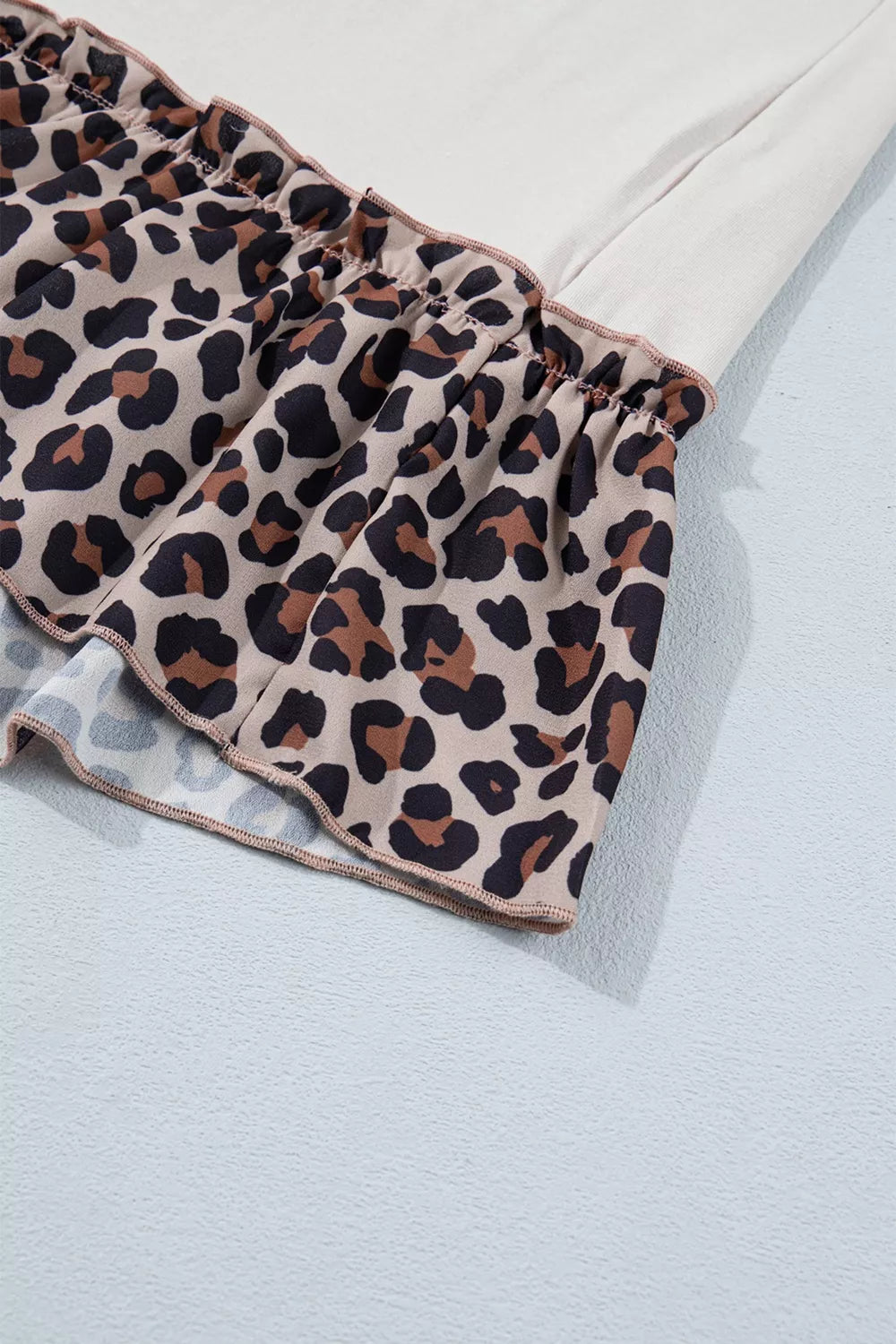 Leopard print fabric on a light blue background