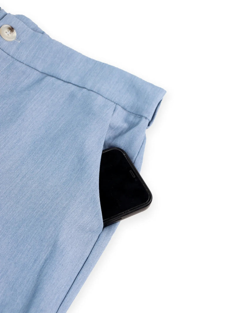 Close-up of a blue fabric with a button on a white background