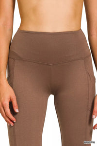 Brown leggings worn by a person on a white background