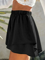 Black skirt worn by a person with a blurred background
