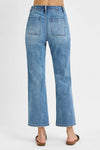 Blue jeans worn by a person on a white background