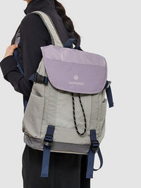 Person wearing a gray and purple backpack with 'Norton' branding on a white background