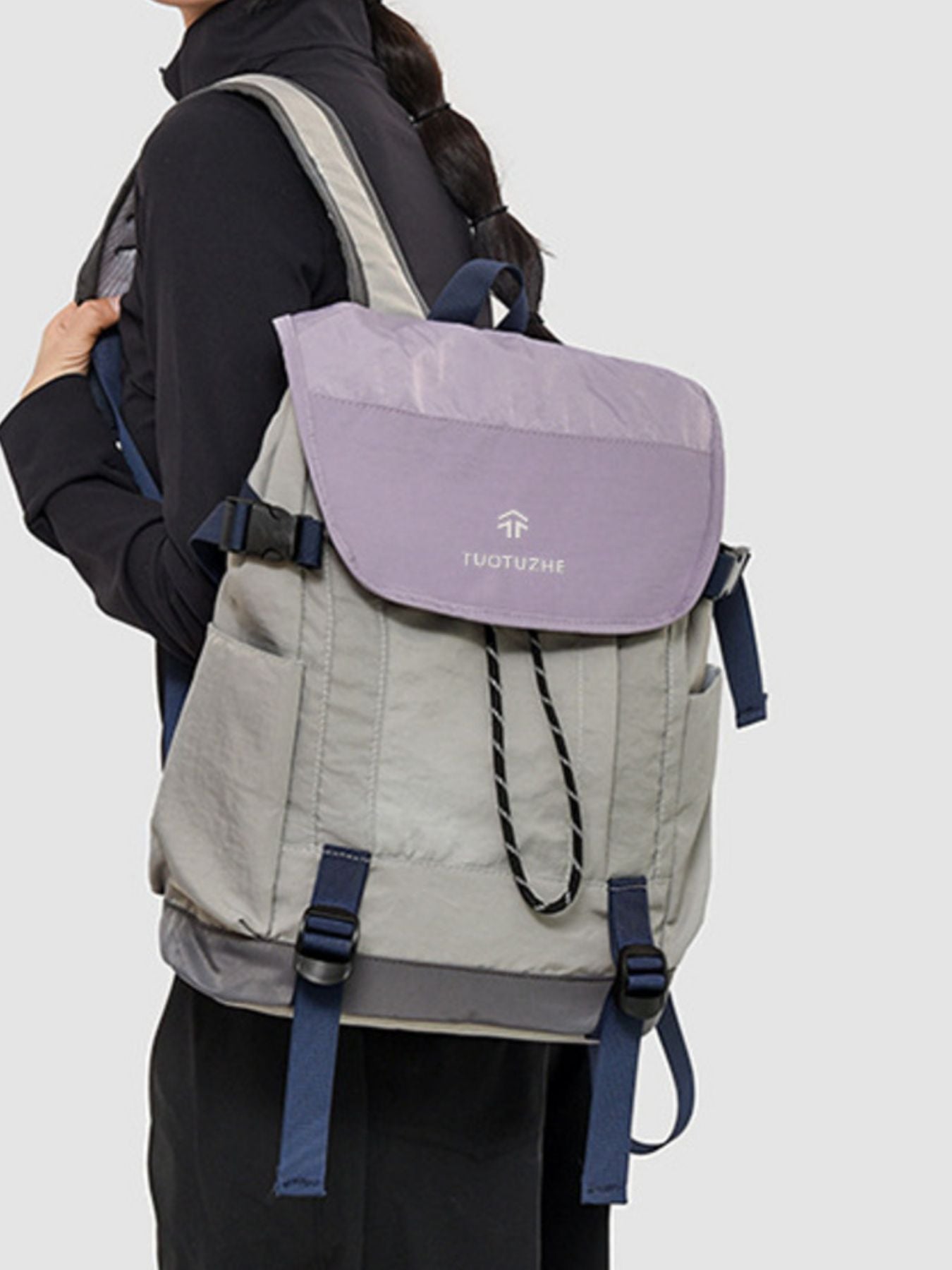 Person wearing a gray and purple backpack with 'Norton' branding on a white background