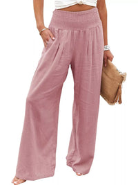 Pink wide-leg pants worn by a person on a white background