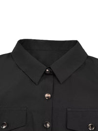 Close-up of a black jacket with silver buttons on a white background