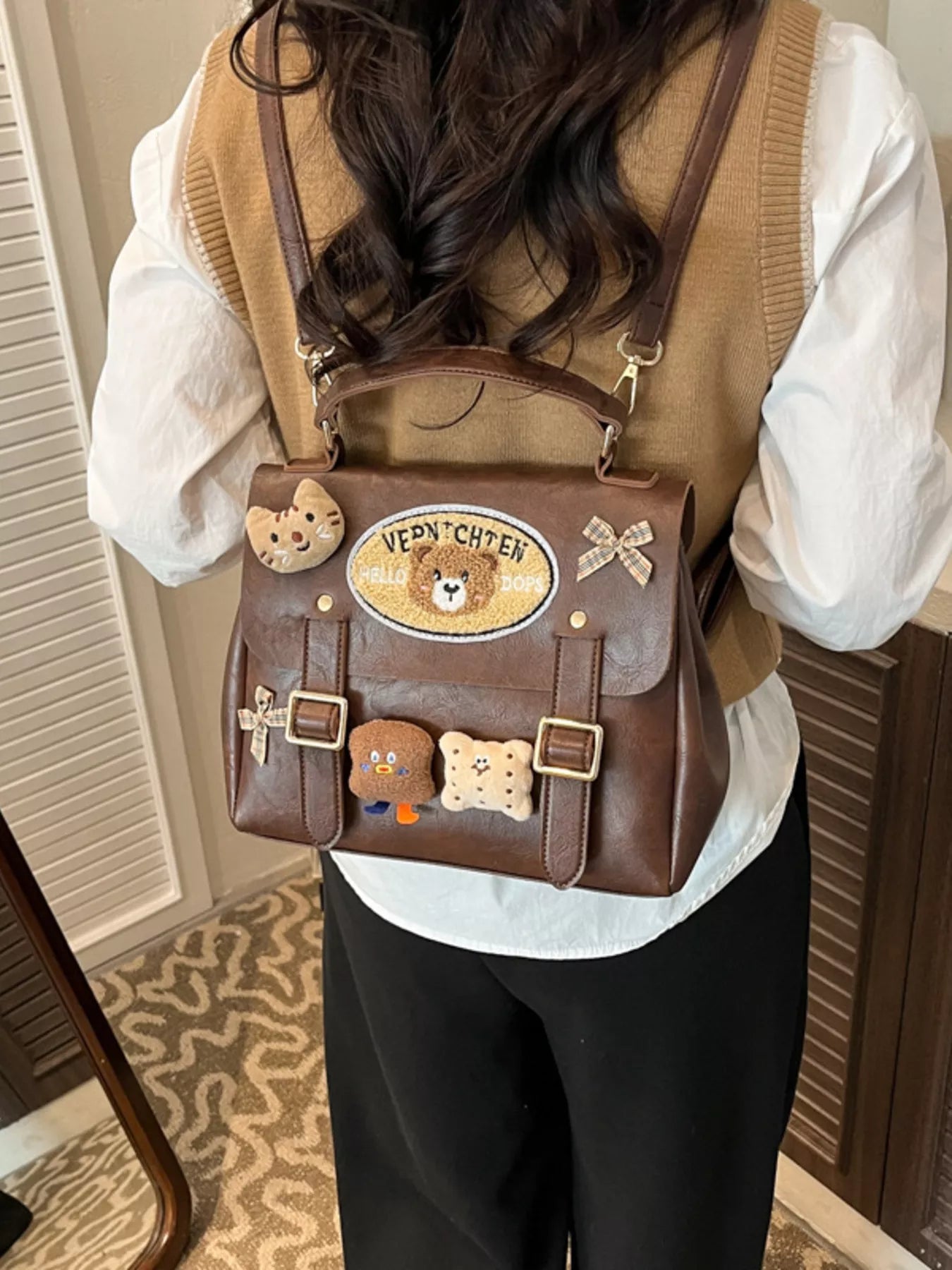 Person wearing a brown backpack with decorative patches