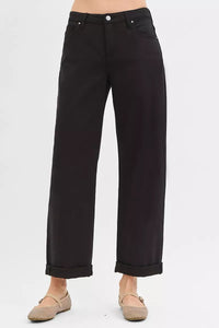 Black pants worn by a person on a white background