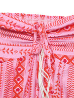 Close-up of a pink and red patterned garment with a drawstring.