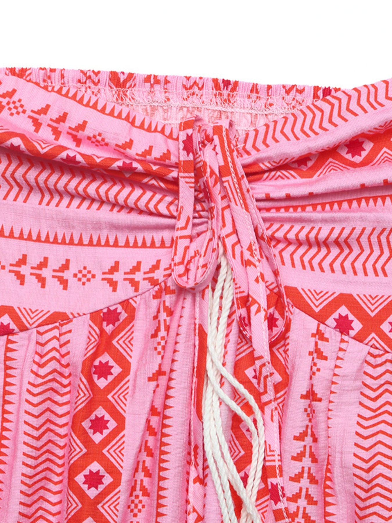 Close-up of a pink and red patterned garment with a drawstring.
