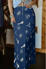 Person wearing a blue skirt with white patterns indoors.