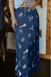 Person wearing a blue skirt with white patterns indoors.
