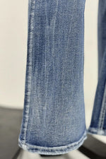Close-up of blue jeans on a white background