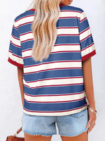 Person wearing a blue, white, and red striped shirt with denim shorts on a white background
