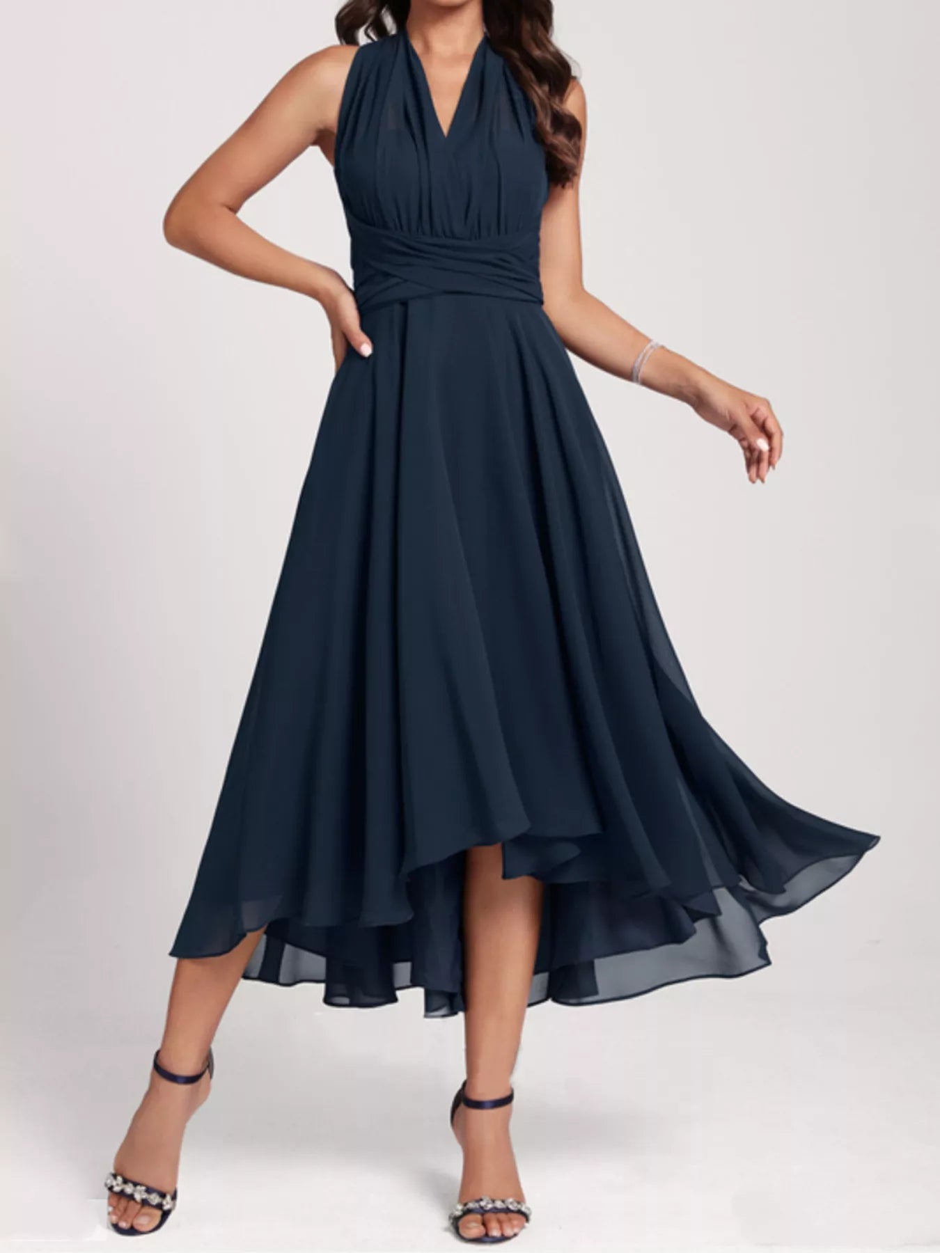 Navy blue dress with a high-low hem on a white background