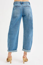 Light blue jeans worn by a person on a white background