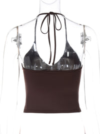 Black halter top with brown waistband on a mannequin against a white background