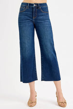 Blue jeans worn by a person on a white background