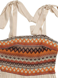 Top with a patterned design and bow straps on a beige background