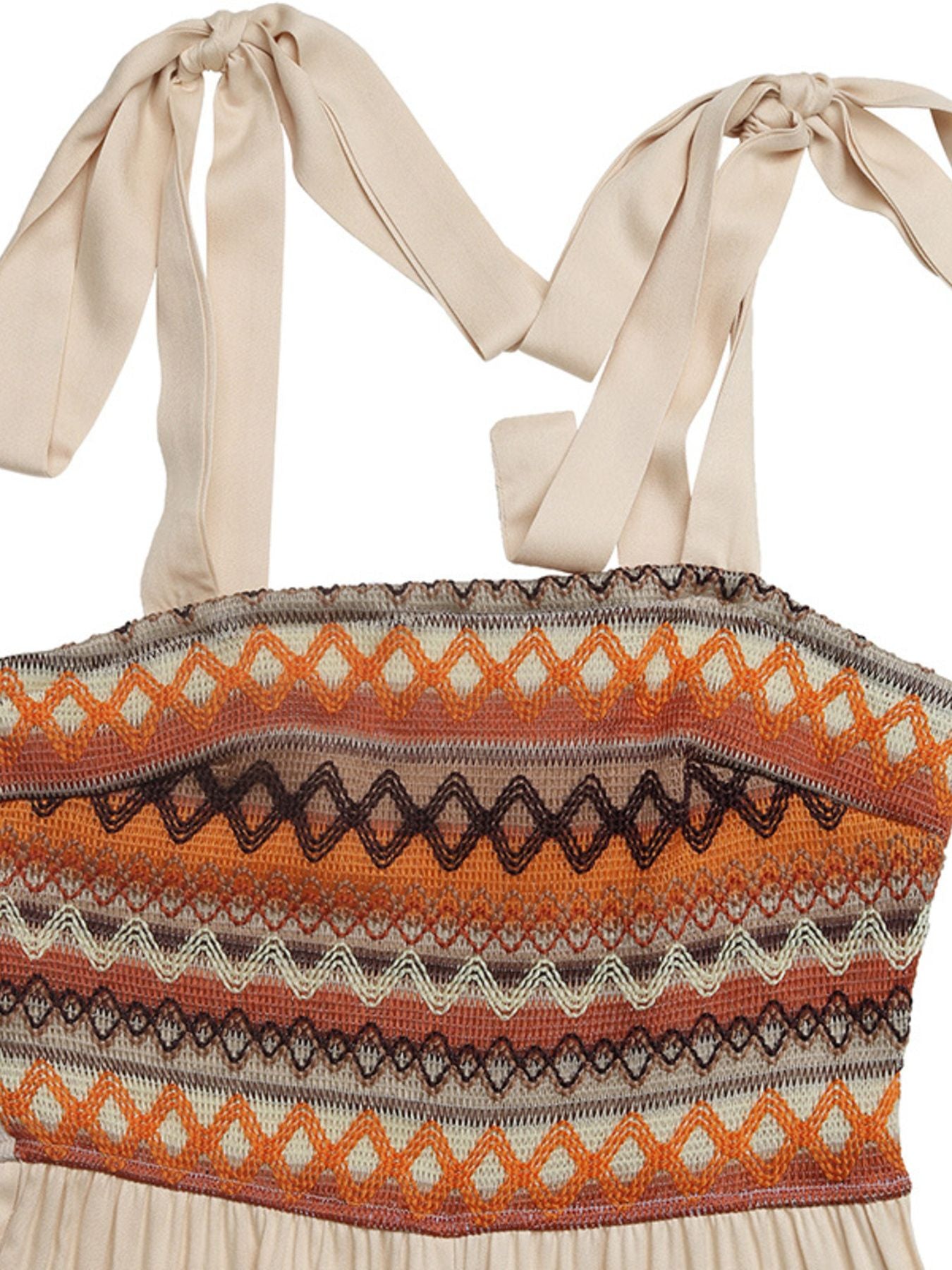 Top with a patterned design and bow straps on a beige background