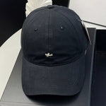 Black cap with a small logo on a black surface
