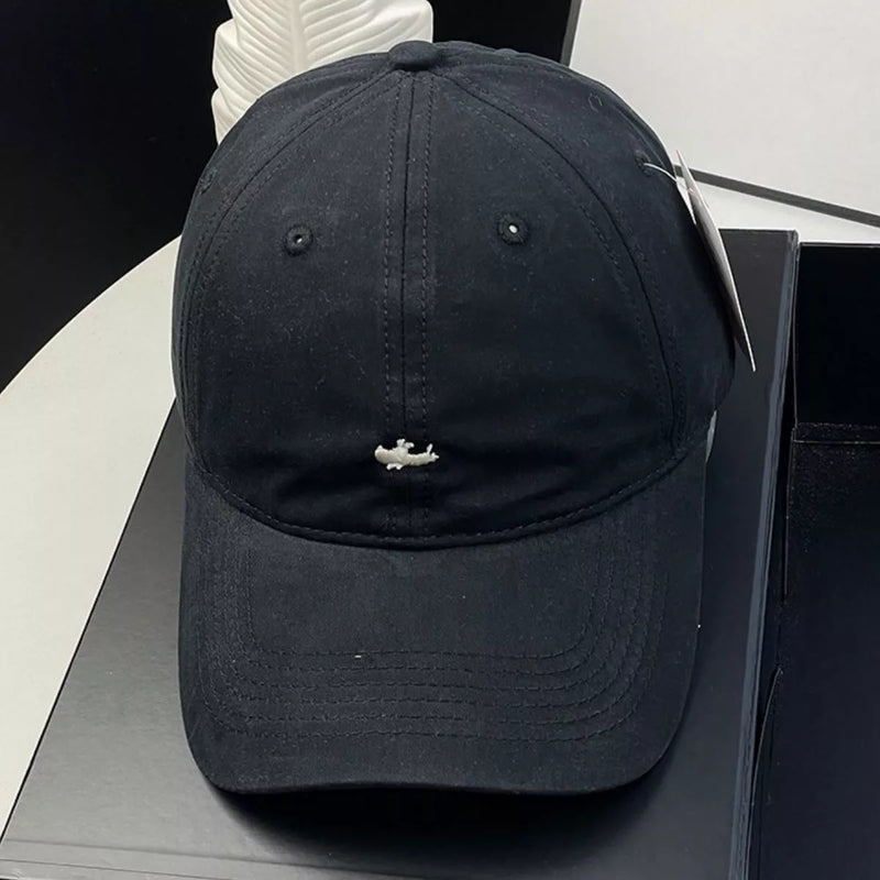 Black cap with a small logo on a black surface