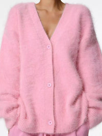 Pink cardigan worn by a person on a white background