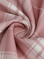 Close-up of pink fabric with a subtle pattern