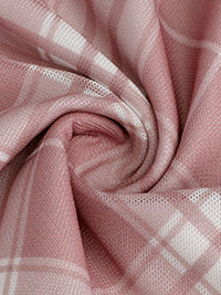 Close-up of pink fabric with a subtle pattern