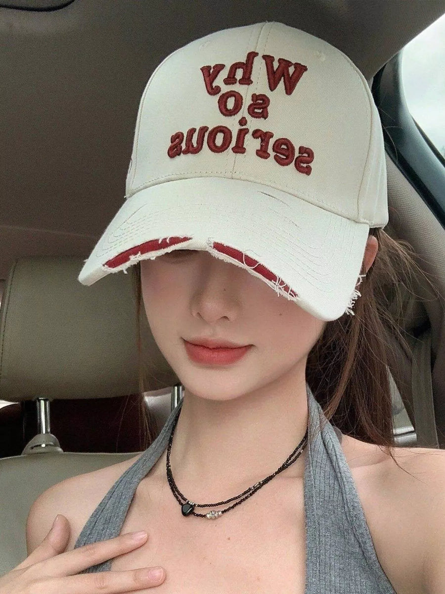 Person wearing a white cap with red text inside a vehicle