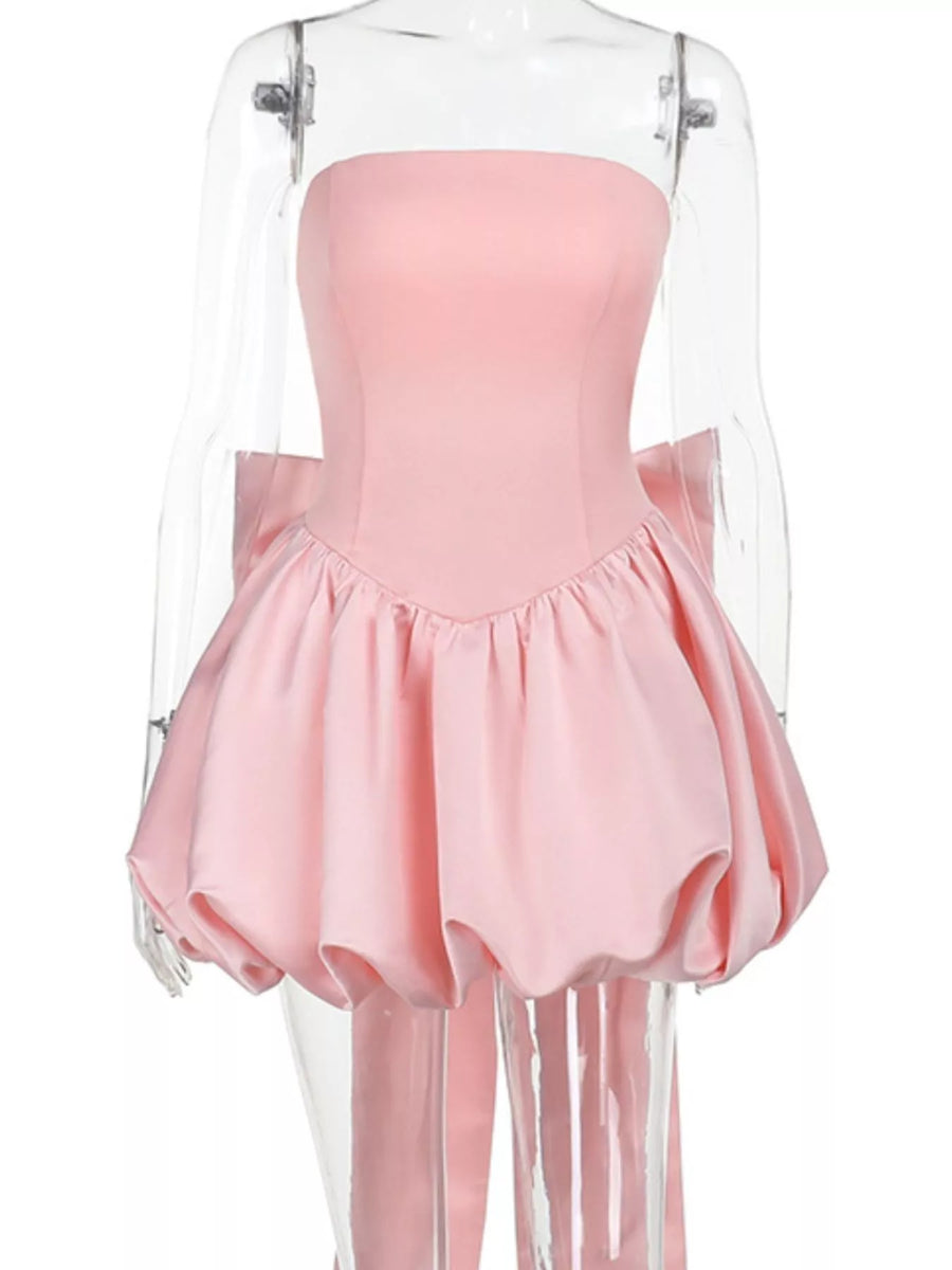 Pink dress with sheer overlay on a white background