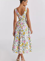 Woman wearing a floral dress on a plain background