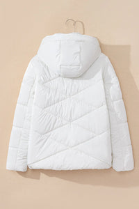 White puffer jacket on a beige background