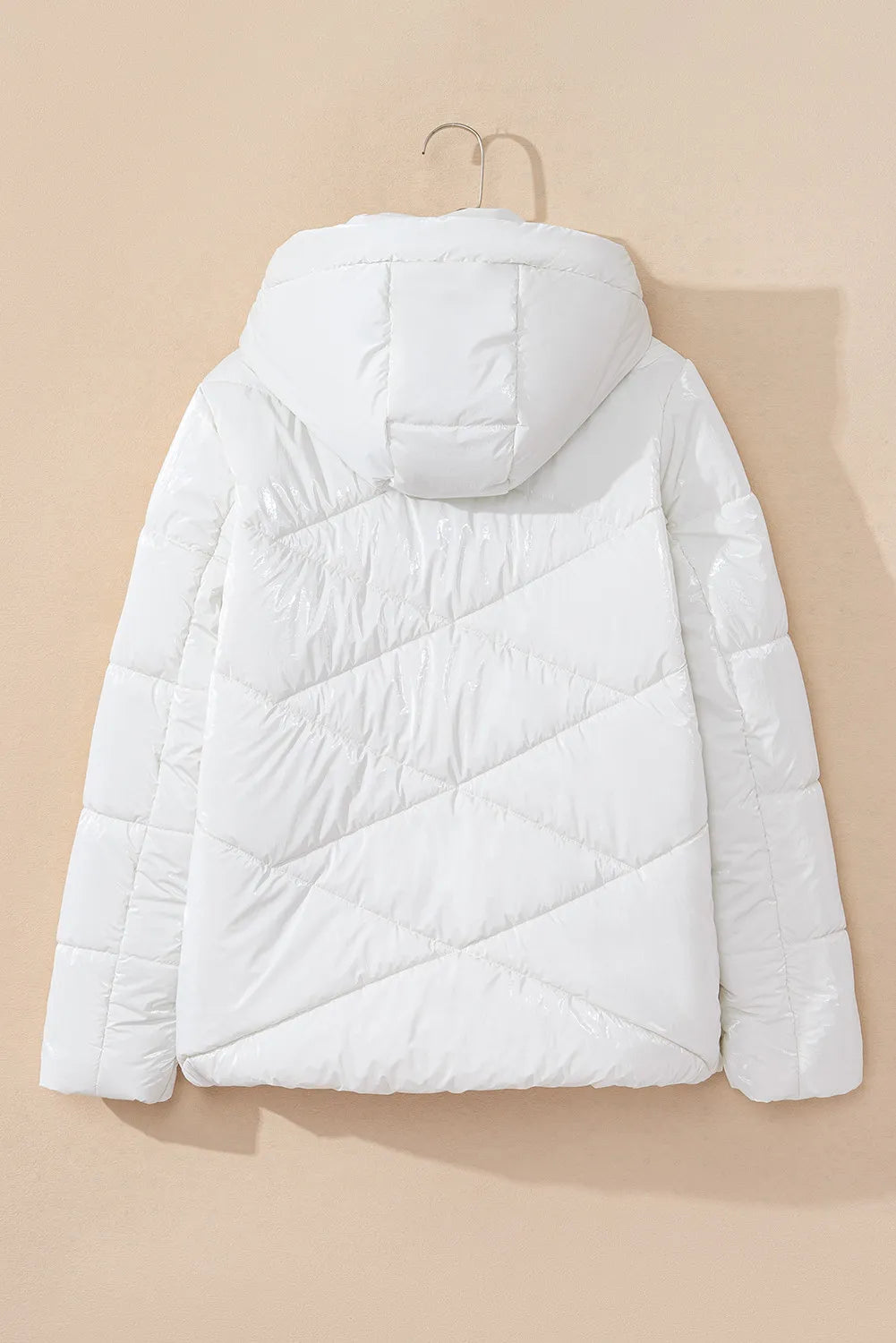 White puffer jacket on a beige background