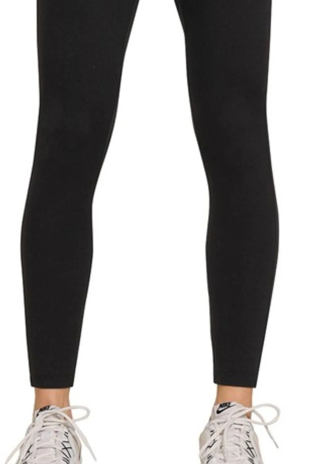 Black leggings worn by a person on a white background