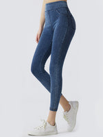 Blue jeans worn by a person on a white background
