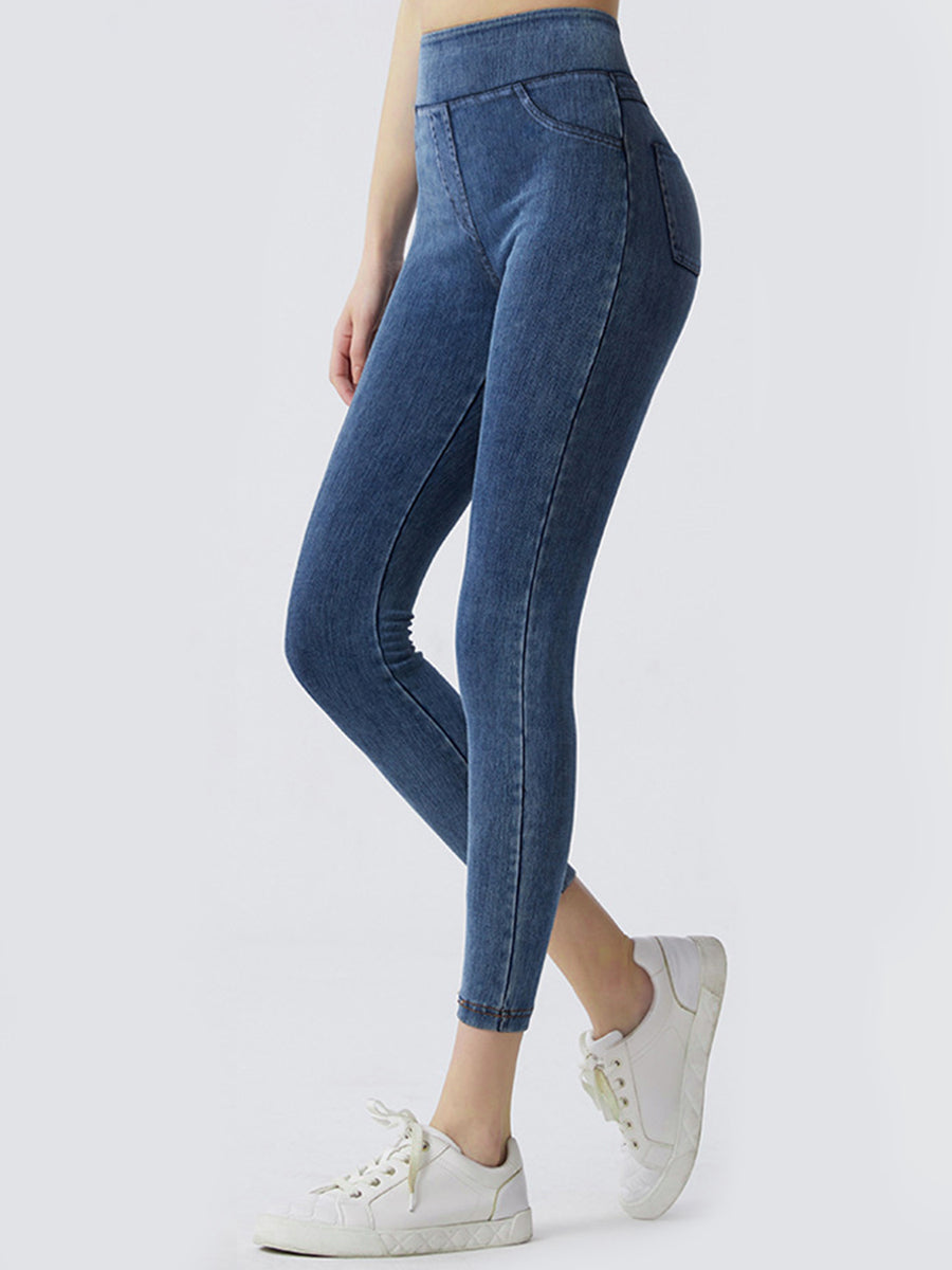 Blue jeans worn by a person on a white background