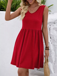 Woman wearing a red dress standing in a snowy landscape