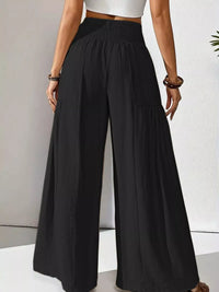Black wide-leg pants worn by a person on a neutral background