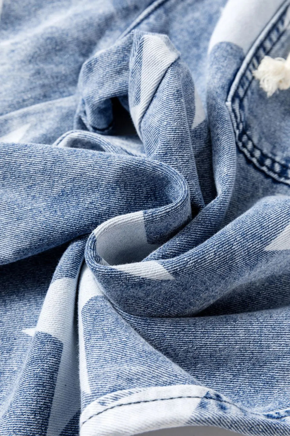 Close-up of blue denim fabric with a soft focus on texture and pattern.