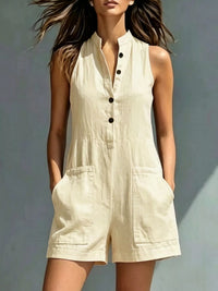 Woman wearing a beige sleeveless jumpsuit against a neutral background