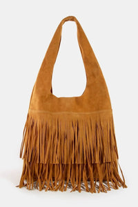 Brown suede handbag with fringe details on a white background
