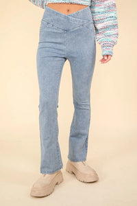 Light blue jeans worn by a person on a beige background