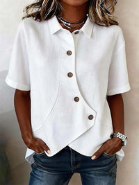 White short-sleeve button-up shirt worn by a person with a neutral background
