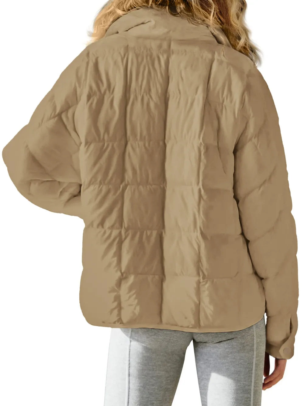 Beige puffer jacket worn by a person on a white background