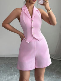 Person wearing a pink outfit with a matching jacket and shorts on a neutral background
