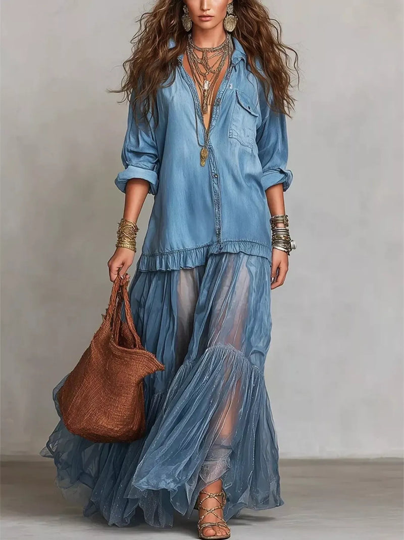 Woman wearing a blue layered outfit with a brown handbag against a neutral background