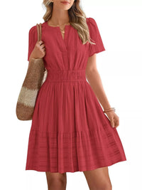 Red dress worn by a person on a white background