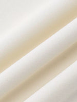 Close-up of beige fabric swatches stacked on top of each other