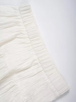 Close-up of a textured white fabric on a light gray background